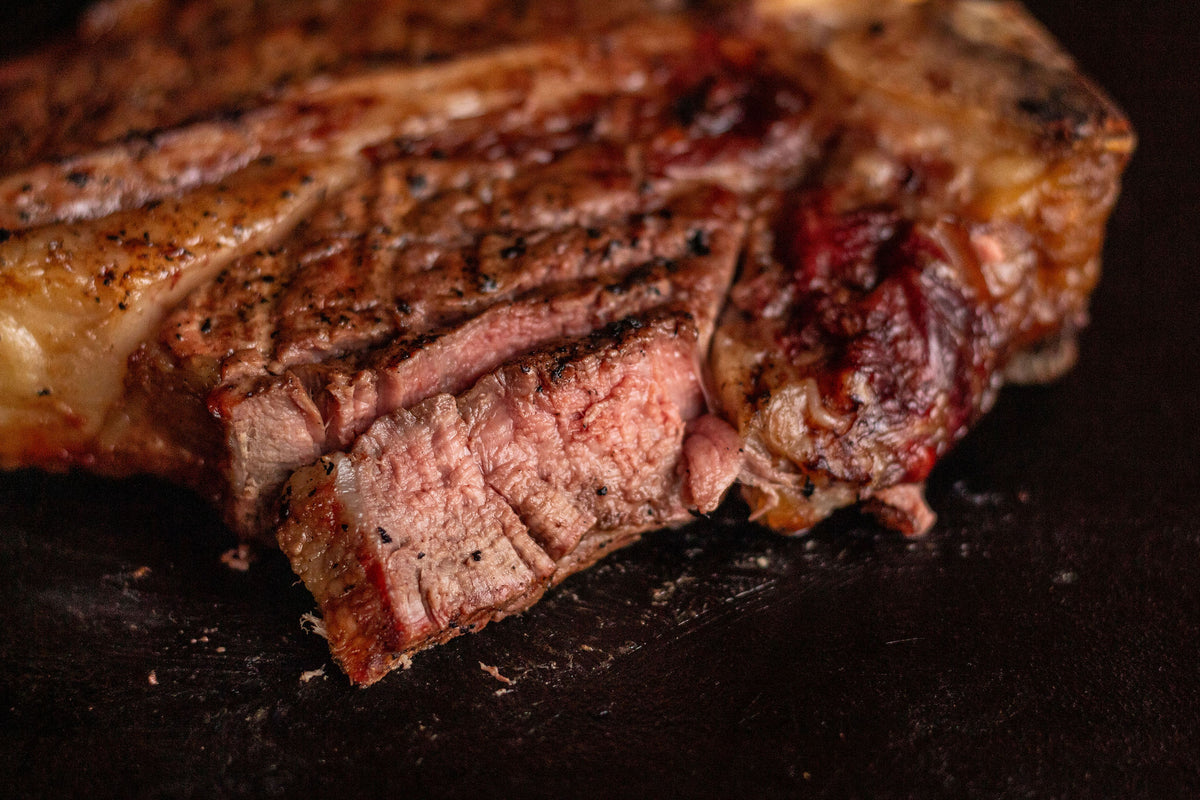 Sliced cooked steak with a browned crust and pink center